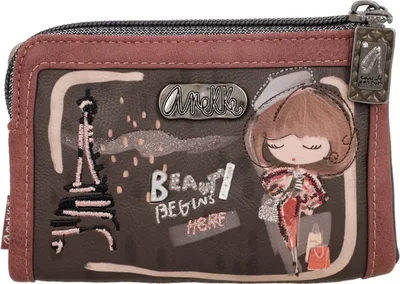 A close-up view of a decorative wallet with an illustration of Paris and a cartoon girl.