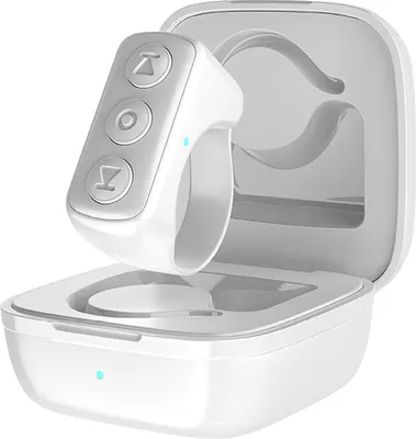 A white ring-shaped remote control and its charging case are shown against a white background.