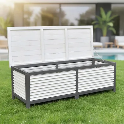 An outdoor storage box is placed on a green lawn in front of a modern house with a swimming pool.