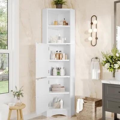 A white corner cabinet filled with bathroom products and towels, placed in a bathroom setting.