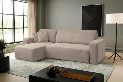 A modern living room with a sectional sofa, coffee table, and floor lamp.
