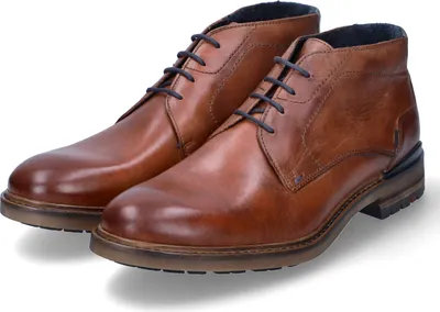 A pair of brown leather chukka boots are shown against a white background.