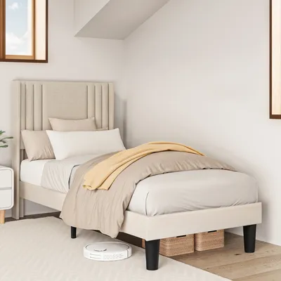 A bedroom scene with a single bed and bedding.