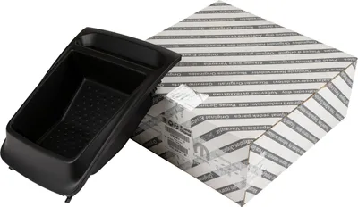 A black storage compartment is shown next to a white and gray striped box.