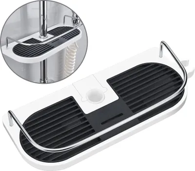 A white and black shower caddy with silver railings is shown on a white background. A close-up inset shows the caddy attached to a shower pipe.