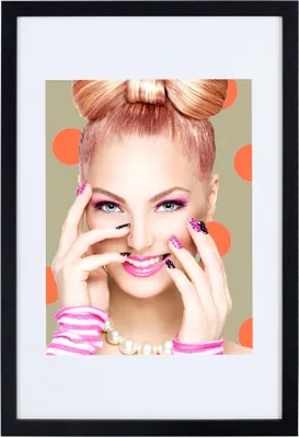 A woman with a bow hairstyle and bright makeup is shown against a polka-dot background.