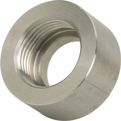 A close-up view of a metal nut with internal threading.
