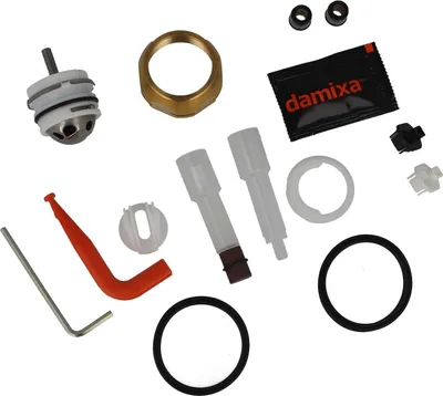 A collection of plumbing parts and tools laid out on a white background.