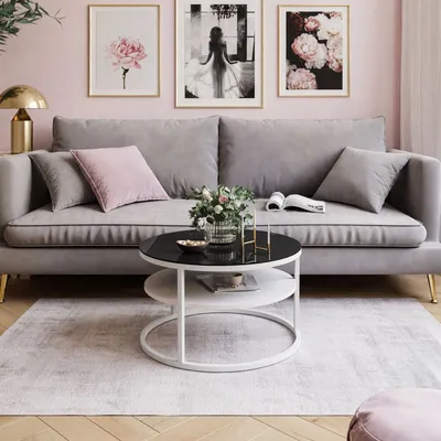 A living room scene with a sofa, coffee table, and artwork.