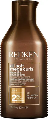 A brown bottle of Redken All Soft Mega Curls Shampoo.
