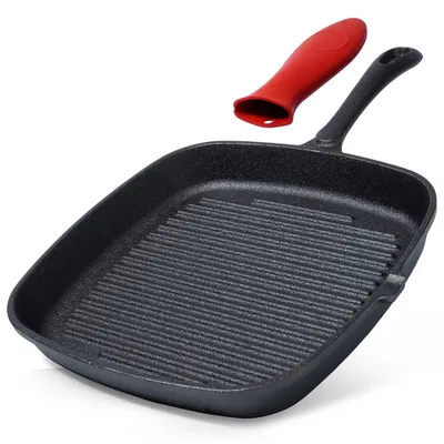 A black cast iron grill pan with a red silicone handle cover is shown against a white background.