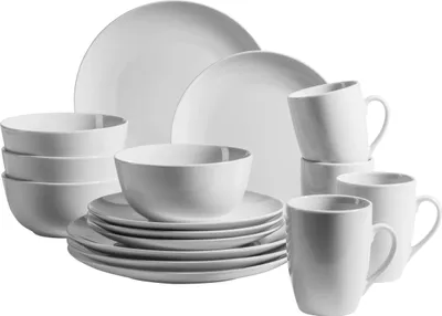 A set of white porcelain dishes and mugs arranged on a white background.