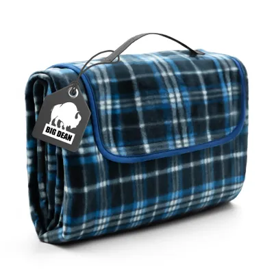 A folded blue and black plaid picnic blanket with a handle and a tag.