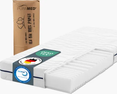 A mattress with a cutaway showing its internal structure, next to its rolled-up packaging.