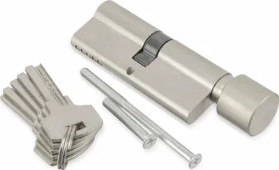 A lock cylinder and keys are laid out on a white background.