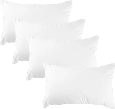 A set of four white pillows arranged diagonally on a white background.