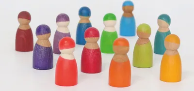 A group of colorful wooden peg dolls arranged on a white background.