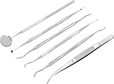 A set of dental tools arranged diagonally on a white background.