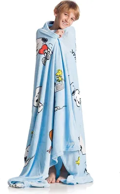 A young boy is wrapped in a light blue blanket with cartoon characters printed on it.