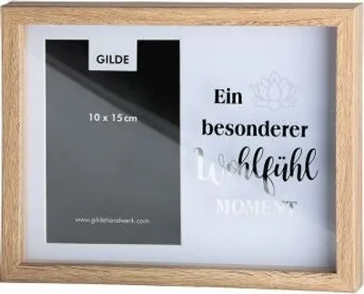 A wooden-framed photo frame with text and a lotus flower graphic.