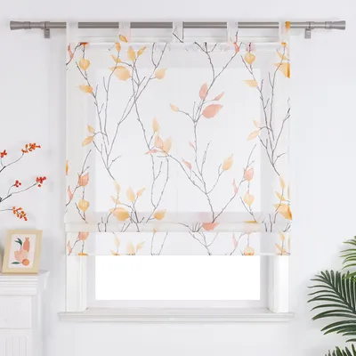 A sheer Roman blind with a branch and leaf pattern is displayed in front of a window.