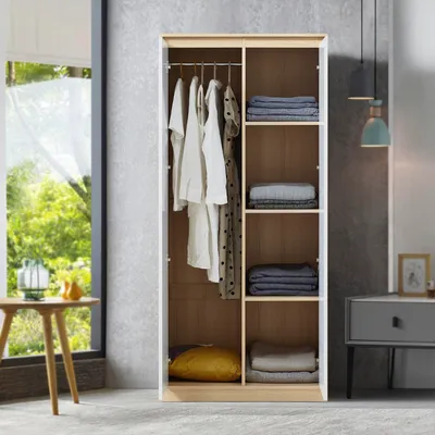 An open wardrobe with clothes hanging and folded items on shelves.