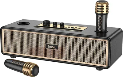 A black and gold Bluetooth speaker with two microphones.