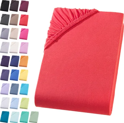 A collection of colorful fitted sheets displayed on a white background, with one red sheet prominently featured in the foreground.