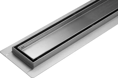 A close-up, angled view of a stainless steel linear shower drain on a white background.