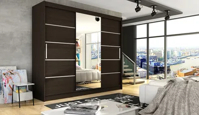 A bedroom scene with a large wardrobe, bed, and a view of a city through a window.
