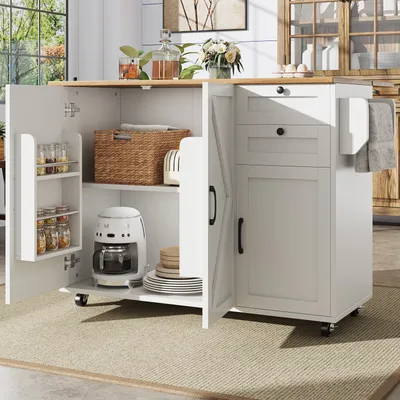 A white kitchen island with a wooden countertop is shown with its doors and drawers open, revealing storage space. The island is placed on a beige rug in a well-lit room.