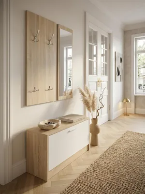 Draufsicht auf eine kompakte Garderobe aus hellem Holz im Flur. Die smarte Aufteilung zeigt den platzsparenden Schuhkipper und die Wandpaneele mit Kleiderhaken für optimale Raumnutzung._#sku_SAFWL5.165#
