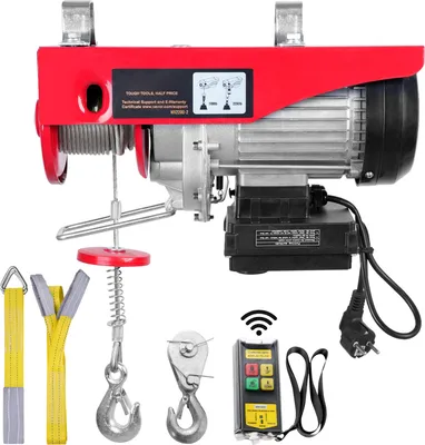 A red electric hoist with various accessories laid out in front of it, including straps, hooks, and a remote control.