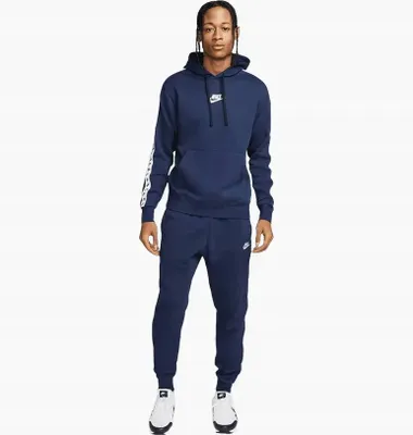 A man wearing a navy blue Nike tracksuit.