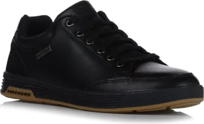A black sneaker with a brown sole is shown against a white background.