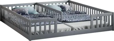 A gray wooden children's bed with two mattresses and bedding.