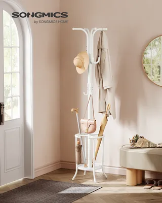 A hallway or entryway scene with a white coat rack, hat, coats, bags, and umbrellas.