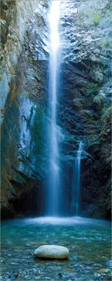 Produktbild von Wallario Poster - Wasserfall bei Sonneneinfall, Kunstdruck Größe: 50 x 125 cm