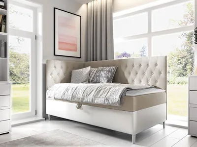 A bedroom scene with a daybed, window, and artwork.