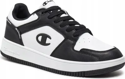 A studio shot of a black and white Champion sneaker.