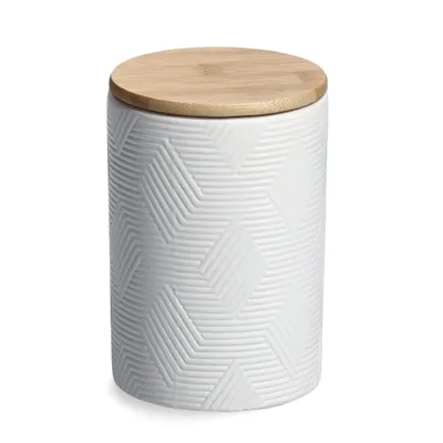A white ceramic storage jar with a textured geometric pattern and a light brown bamboo lid, shown against a white background.
