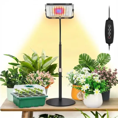 A grow light setup with plants on a table.