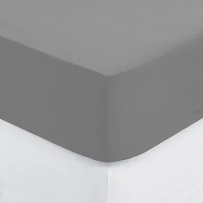 A close-up view of a grey fitted sheet on a white surface.