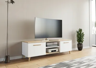 A modern TV stand with a television and electronic devices in a living room setting.