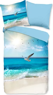 A duvet cover and pillowcase set featuring a beach scene with seagulls and the sun.