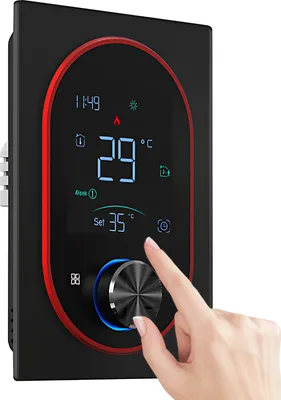 A close-up of a digital thermostat with a hand interacting with the control dial.