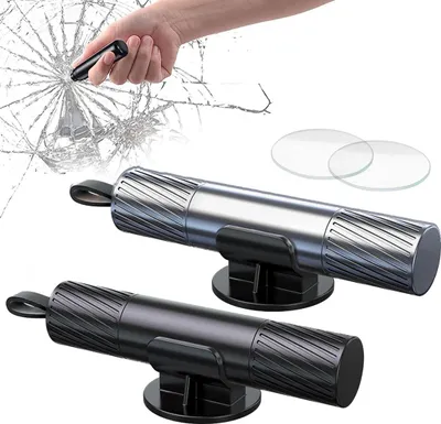 A hand is shown breaking a car window with a safety hammer, with two safety hammers on stands in the foreground.