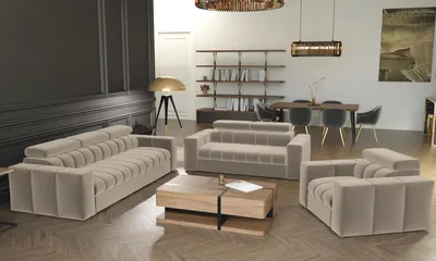 A modern living room with a beige sofa set, coffee table, and bookshelf.