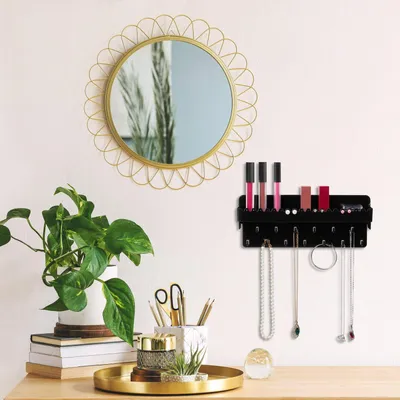 A vanity or dressing table setup with a mirror, jewelry organizer, and decorative items.