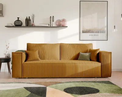 A modern living room scene featuring a mustard yellow corduroy sofa, a shelf with decorative items, and a large framed artwork on the wall.